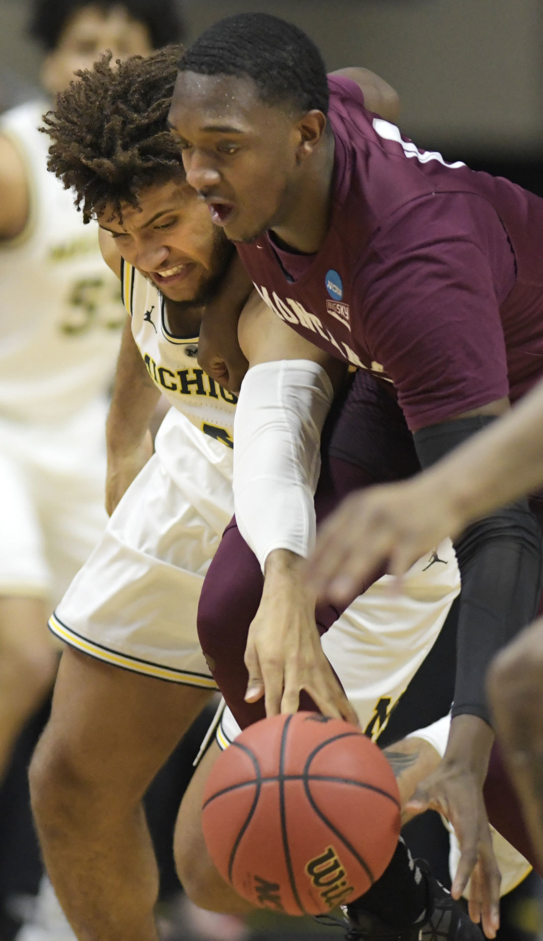 Michigan's Isaiah Livers battles Montana's Donaven Dorsey